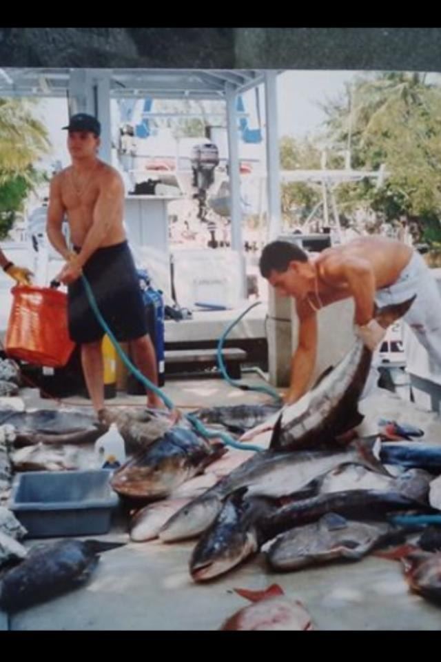 Family members cleaning the day's catch at the dock, years ago